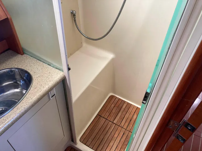 Fela Yacht Photos Pics 2009 Hunter 49 Aft Cockpit shower with wooden floor and adjacent sink.