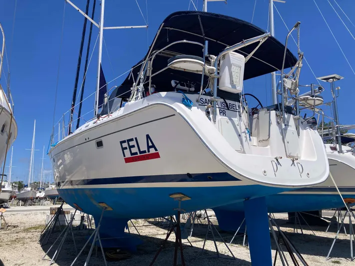Fela Yacht Photos Pics 2009 Hunter 49 Aft Cockpit sailboat on stands, blue hull, sunny day.