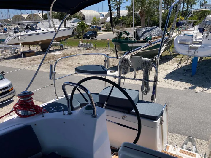 Fela Yacht Photos Pics 2009 Hunter 49 Aft Cockpit sailboat in a marina, featuring steering wheel and deck view.