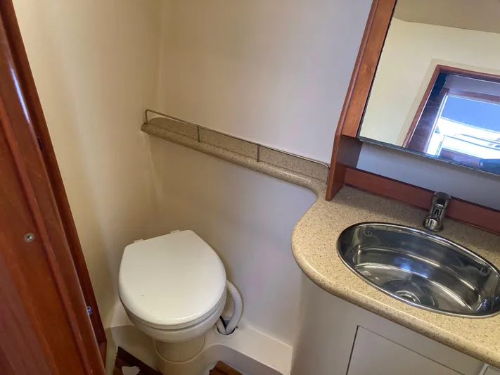 Fela Yacht Photos Pics 2009 Hunter 49 Aft Cockpit bathroom with toilet, sink, and mirror.