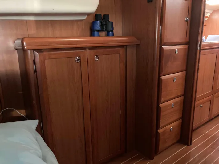 Fela Yacht Photos Pics 2009 Hunter 49 Aft Cockpit interior with wooden cabinets and drawers.