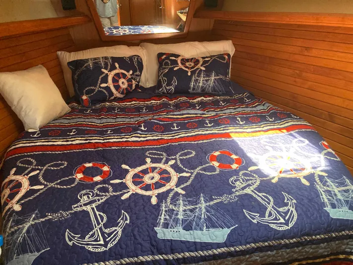 Fela Yacht Photos Pics Nautical-themed bedding in a 2009 Hunter 49 Aft Cockpit cabin, featuring anchors and ships.