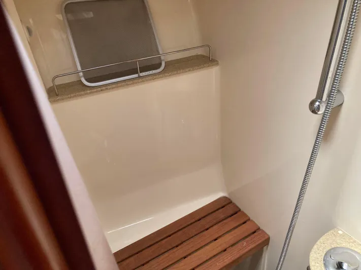 Fela Yacht Photos Pics 2009 Hunter 49 Aft Cockpit shower with wooden bench and handheld showerhead.