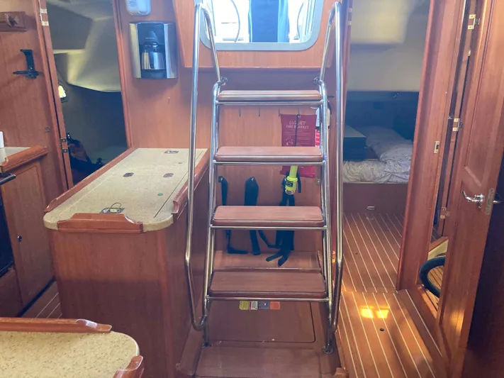 Fela Yacht Photos Pics Interior of 2009 Hunter 49 Aft Cockpit yacht with wooden stairs and cozy cabin.