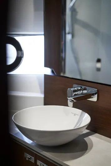  Yacht Photos Pics Modern bathroom sink in 2021 Princess S66 yacht, featuring sleek design and chrome fixtures.
