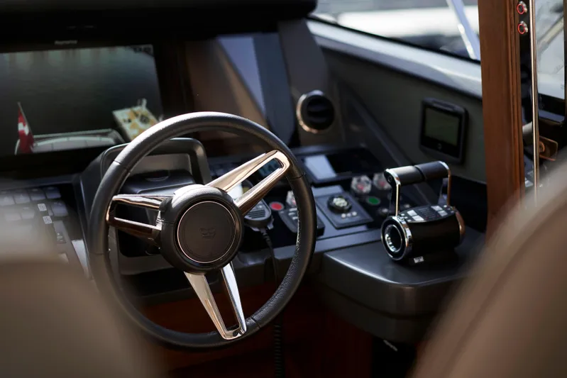 Yacht Photos Pics Steering wheel and controls of a 2021 Princess S66 yacht cockpit.