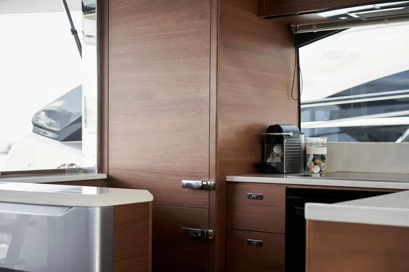  Yacht Photos Pics Luxurious interior of 2021 Princess S66 yacht with modern kitchen amenities.