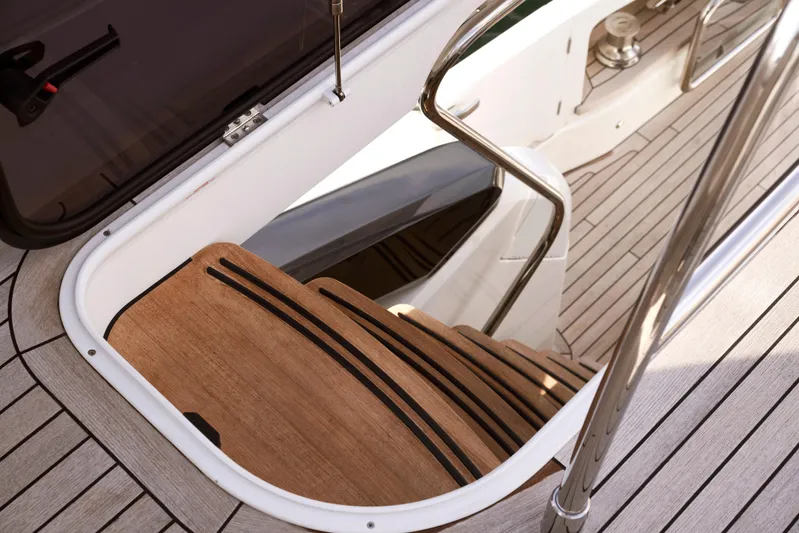  Yacht Photos Pics Staircase on 2021 Princess S66 yacht with wooden steps and sleek railing.