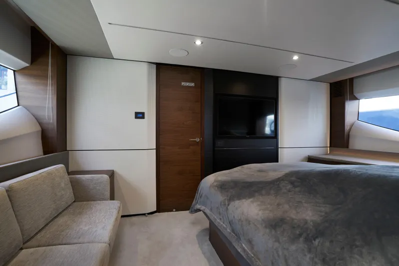  Yacht Photos Pics Luxurious interior of 2021 Princess S66 yacht with modern furnishings and cozy bedding.