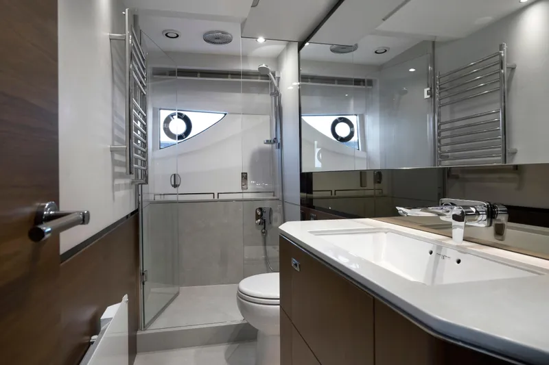  Yacht Photos Pics Luxurious bathroom in 2021 Princess S66 yacht with modern fixtures and elegant design.