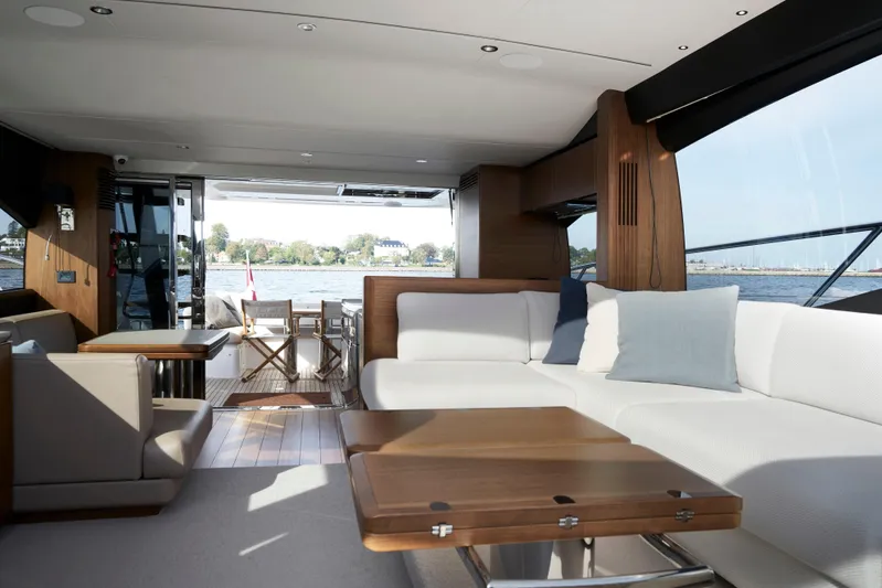  Yacht Photos Pics Luxurious interior of 2021 Princess S66 yacht with elegant seating and wooden accents.