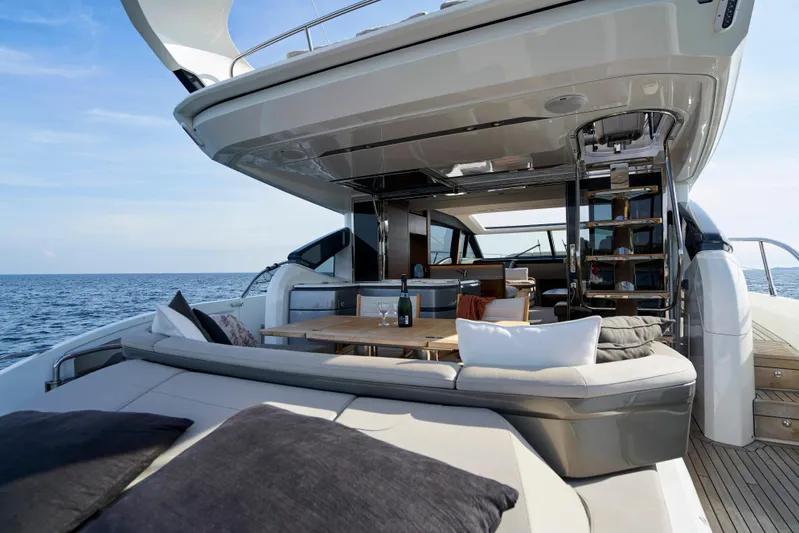  Yacht Photos Pics Luxurious 2021 Princess S66 yacht with elegant outdoor seating and dining area at sea.
