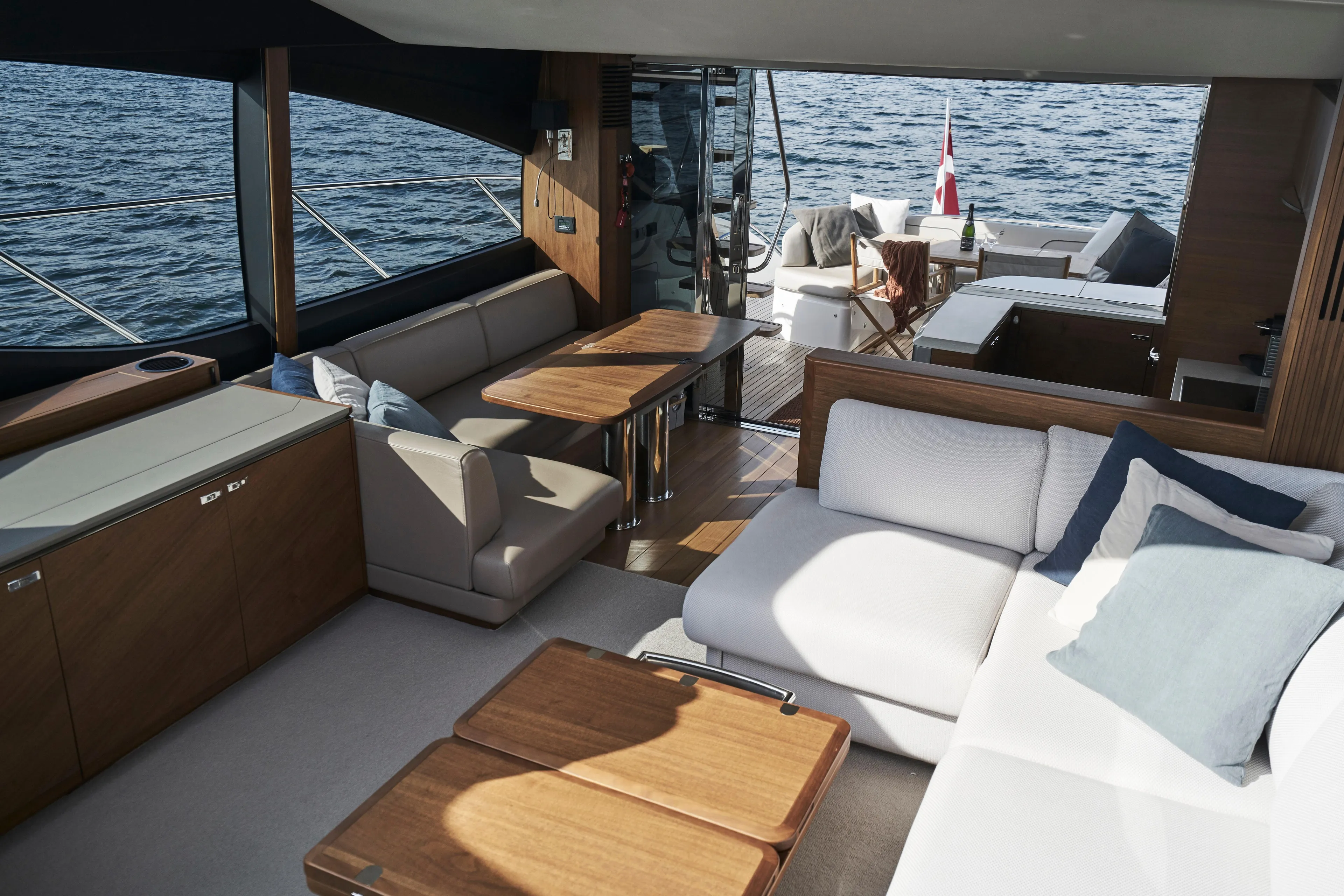  Yacht Photos Pics Luxurious interior of 2021 Princess S66 yacht with elegant seating and wooden accents.