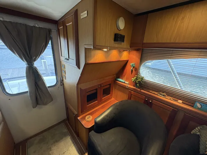 Rabbit Hole Yacht Photos Pics Interior of 2005 Luhrs 41 Convertible yacht with wood paneling and seating area.