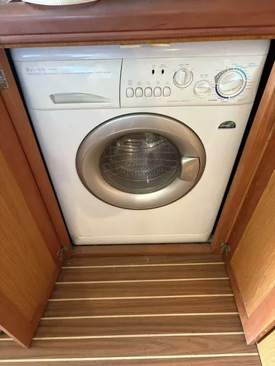 Rabbit Hole Yacht Photos Pics Washing machine inside a wooden cabinet on a 2005 Luhrs 41 Convertible boat.