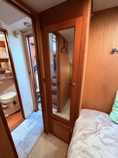 Rabbit Hole Yacht Photos Pics Interior of 2005 Luhrs 41 Convertible yacht, featuring a cozy bedroom and bathroom.