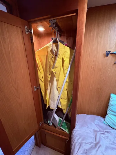 Rabbit Hole Yacht Photos Pics Wooden closet with yellow raincoat inside Luhrs 41 Convertible boat, 2005 model.