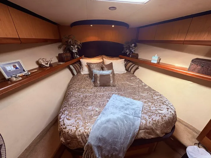 Rabbit Hole Yacht Photos Pics Luxurious bedroom interior of 2005 Luhrs 41 Convertible yacht with elegant bedding and decor.
