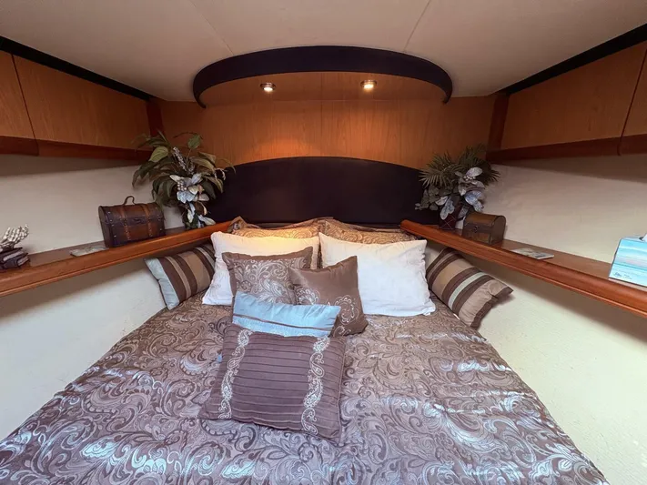 Rabbit Hole Yacht Photos Pics Luxurious bedroom interior of 2005 Luhrs 41 Convertible yacht with elegant bedding and decor.