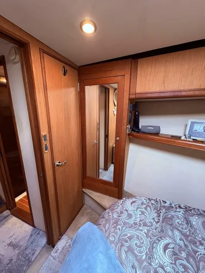 Rabbit Hole Yacht Photos Pics 2005 Luhrs 41 Convertible cabin interior with wood paneling and cozy bedding.