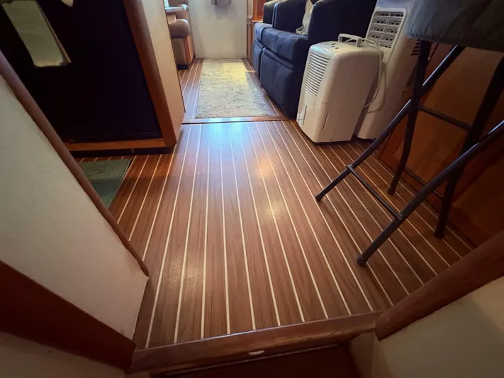 Rabbit Hole Yacht Photos Pics Interior of 2005 Luhrs 41 Convertible with wood flooring and modern furnishings.