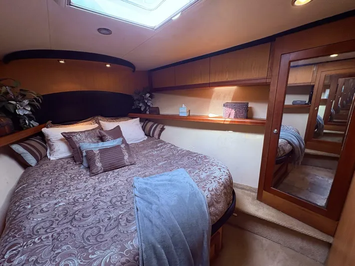 Rabbit Hole Yacht Photos Pics Luxurious bedroom in 2005 Luhrs 41 Convertible yacht with elegant bedding and mirrored closet.