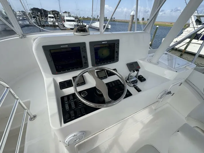 Rabbit Hole Yacht Photos Pics 2005 Luhrs 41 Convertible helm with dual displays and steering wheel, docked at marina.