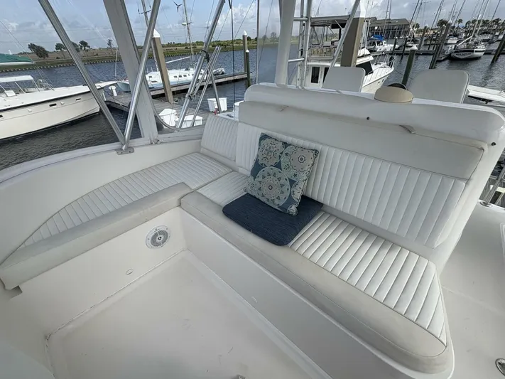 Rabbit Hole Yacht Photos Pics 2005 Luhrs 41 Convertible yacht seating area with cushion, docked at marina.