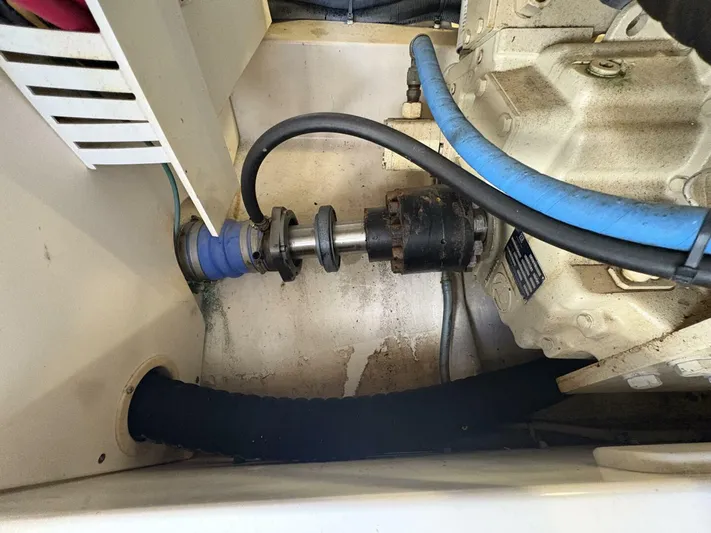 Rabbit Hole Yacht Photos Pics Engine compartment of a 2005 Luhrs 41 Convertible boat, showing mechanical components and hoses.