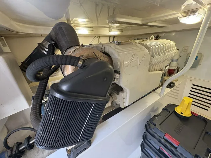 Rabbit Hole Yacht Photos Pics Engine room of 2005 Luhrs 41 Convertible boat, showcasing engine components and storage.