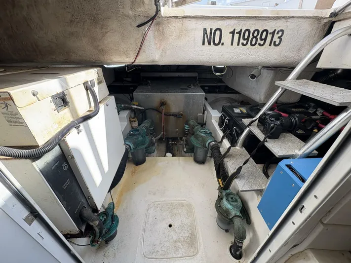 Rabbit Hole Yacht Photos Pics Engine room of 2005 Luhrs 41 Convertible boat, showing equipment and ladder.