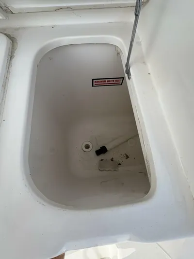 Rabbit Hole Yacht Photos Pics 2005 Luhrs 41 Convertible boat storage compartment, open lid, white interior.