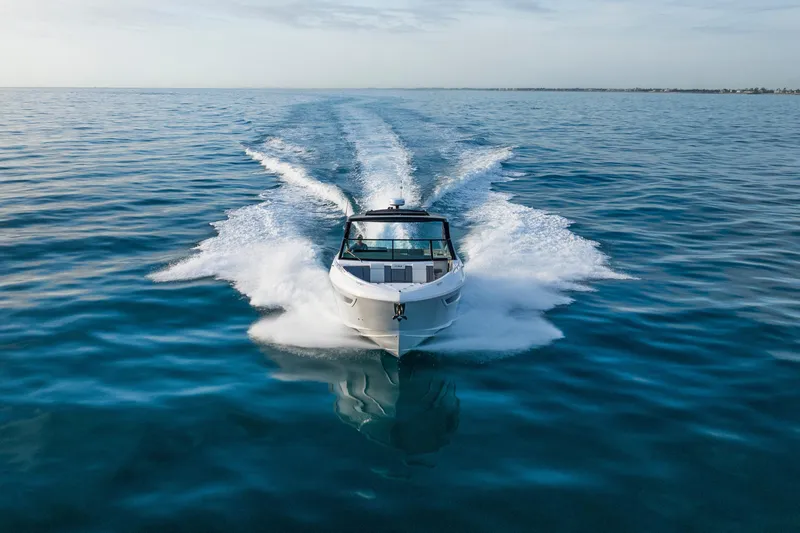  Yacht Photos Pics 2026 Cruisers Yachts 38 GLS OB speeding on open water, creating a dynamic wake.