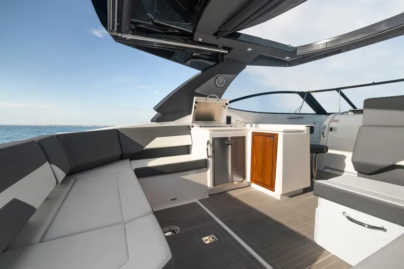  Yacht Photos Pics Luxurious interior of 2026 Cruisers Yachts 38 GLS OB with sleek seating and kitchenette.