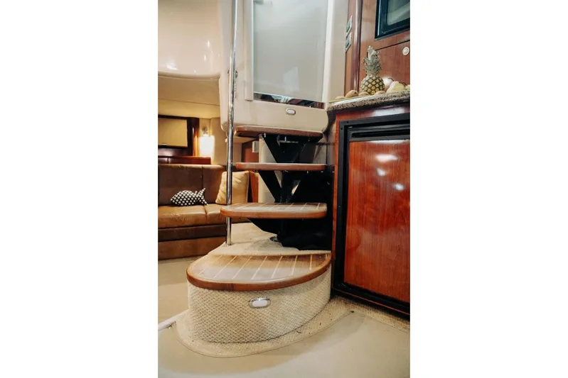  Yacht Photos Pics Interior of 2005 Searay Sundancer 390 yacht with wooden steps and cozy seating area.