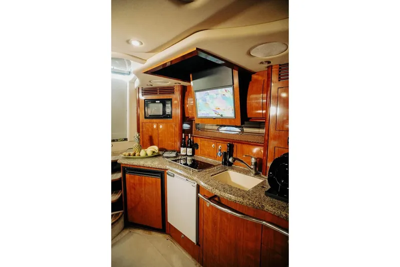  Yacht Photos Pics Luxurious 2005 Searay Sundancer 390 yacht kitchen with wood cabinetry and modern amenities.