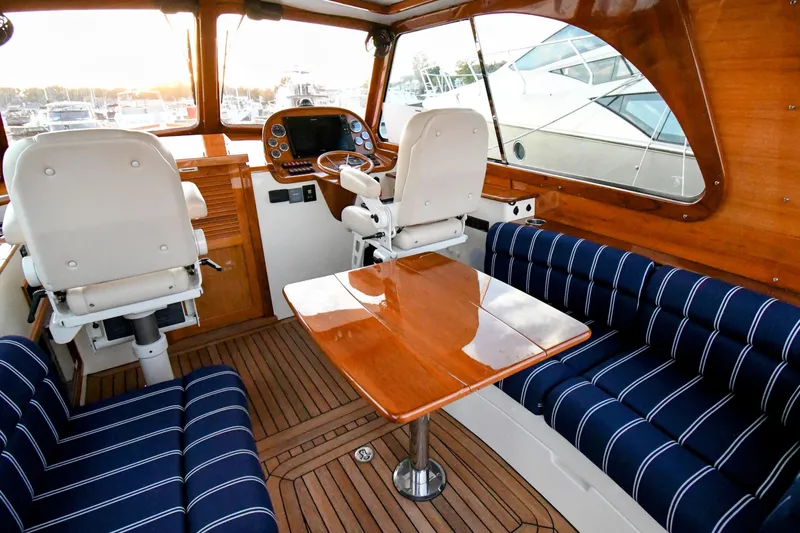 Annie Beau Yacht Photos Pics Interior of 2011 Hinckley Picnic Boat 37 MKIII with elegant seating and wooden finishes.