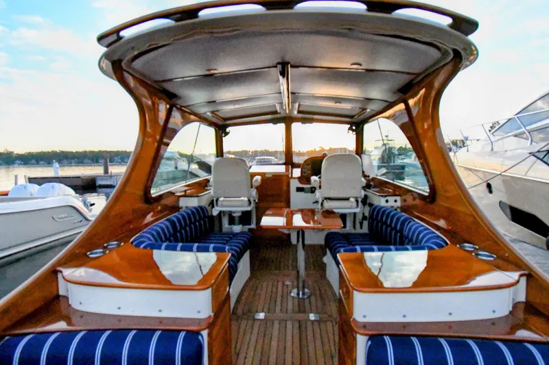Annie Beau Yacht Photos Pics 2011 Hinckley Picnic Boat 37 MKIII interior with elegant wood finish and striped seating.