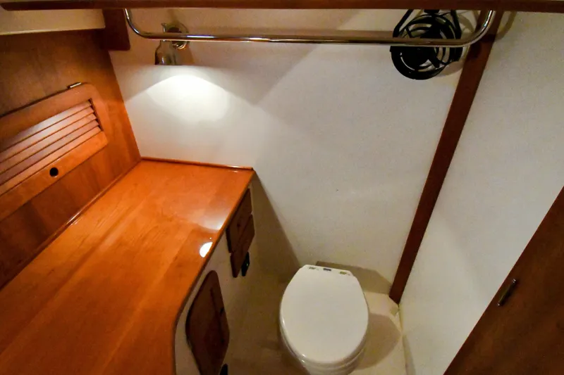 Annie Beau Yacht Photos Pics Hinckley Picnic Boat 37 MKIII 2011 interior with wooden cabinetry and compact toilet.