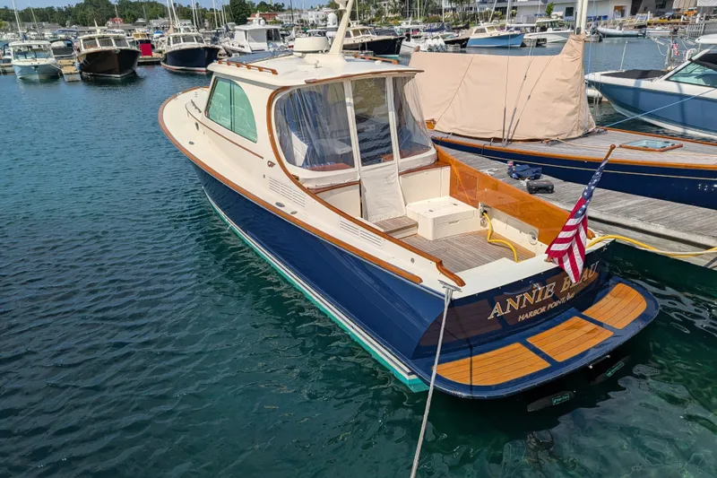 Annie Beau Yacht Photos Pics Hinckley Picnic Boat 37 MKIII, 2011, docked with American flag, elegant design, blue hull.