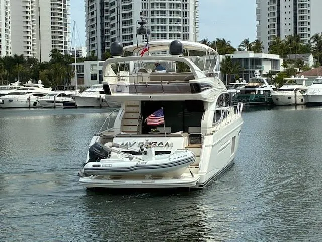 Mv Dream Yacht Photos Pics Luxury 2012 Viking Princess Fly yacht docked in marina with cityscape background.