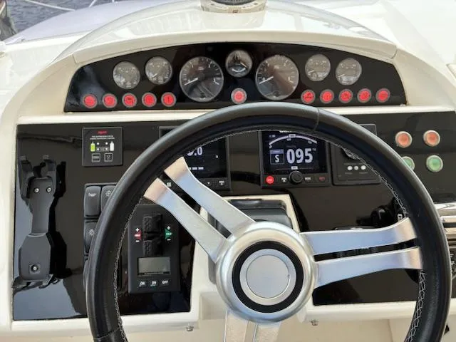 Mv Dream Yacht Photos Pics Steering wheel and dashboard of 2012 Viking Princess Fly yacht, featuring gauges and controls.