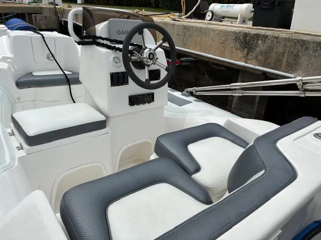 Mv Dream Yacht Photos Pics 2012 Viking Princess Fly boat interior with steering wheel and cushioned seating.