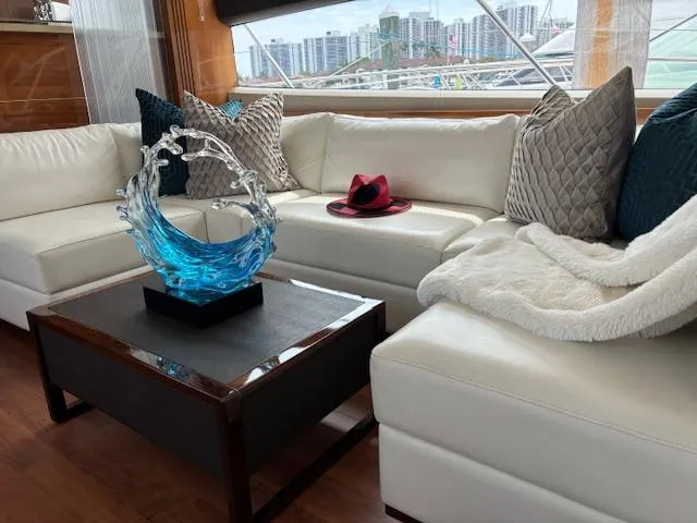 Mv Dream Yacht Photos Pics Luxurious 2012 Viking Princess Fly yacht interior with white leather seating and decorative glass sculpture.