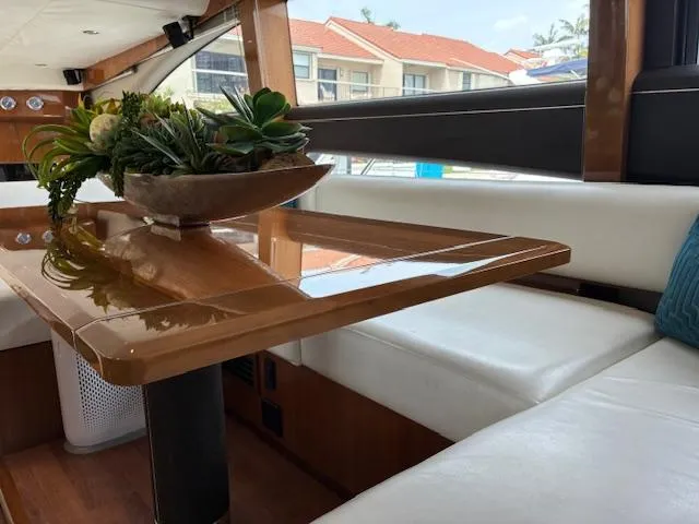 Mv Dream Yacht Photos Pics Luxurious interior of 2012 Viking Princess Fly yacht with elegant wooden table and white seating.