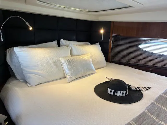 Mv Dream Yacht Photos Pics Luxurious bedroom interior of 2012 Viking Princess Fly yacht with elegant bedding and stylish decor.