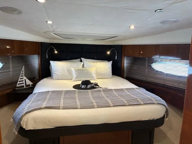 Mv Dream Yacht Photos Pics Luxurious bedroom interior of 2012 Viking Princess Fly yacht with elegant bedding and modern lighting.