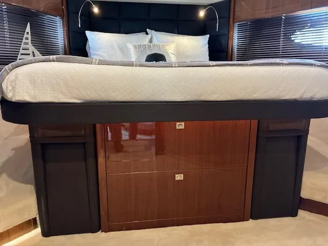 Mv Dream Yacht Photos Pics Luxurious bedroom interior of 2012 Viking Princess Fly yacht with elegant wood finish.