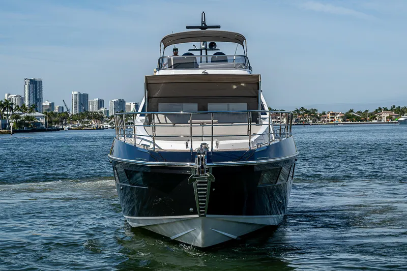  Yacht Photos Pics 2019 Azimut S7 yacht cruising in a coastal cityscape.