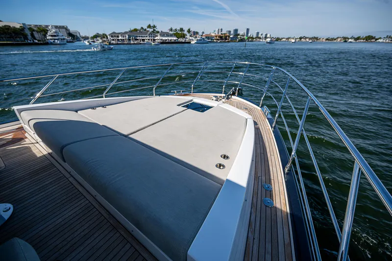  Yacht Photos Pics 2019 Azimut S7 yacht bow with sunbathing area, cruising on a scenic waterway.